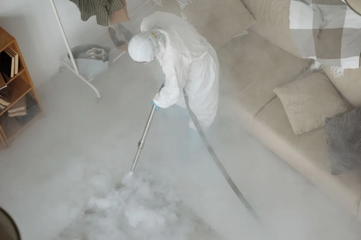 Biohazard cleanup technician in protective equipment, Cooper, TX